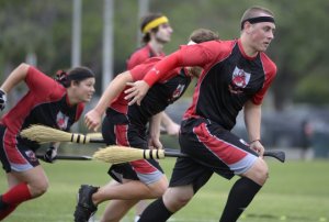 Silicon Valley Skrewts' Willis Miles IV, right, leads his team to the quaffles at the center of the field during a scrimmage against the University of Ottawa Quidditch team at the Quidditch World Cup in Kissimmee, Fla., Friday, April 12, 2013. Quidditch is a game born within the pages of Harry Potter novels, but in recent years it's become a real-life sport. The game is a co-ed, full contact sport that combines elements of rugby, dodgeball and Olympic handball. (AP Photo/Phelan M. Ebenhack) ORG XMIT: FLPE109
